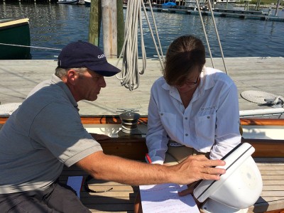 Kevin Boughton of Midcoast Marine Electronics helps skipper Carol Vernon sort out an electronics miscommunication issue